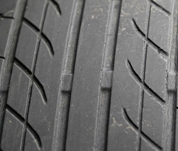 スリップサインは、タイヤ側面の三角の矢印が示す部分の接地面の溝のなかに四角い盛り上がった部分。残り溝の深さが1.6mmになった時にスリップさんが出てくる仕組み<br>