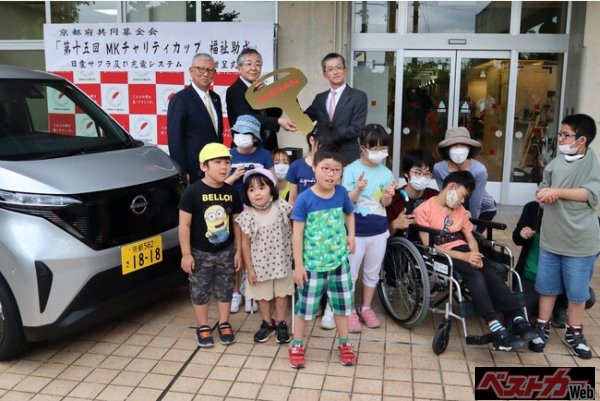 MKチャリティカップ寄付活動で日産軽EV「サクラ」を寄贈。子どもたちへの環境学習やV2H対応充電器で災害時の非常電源にも。