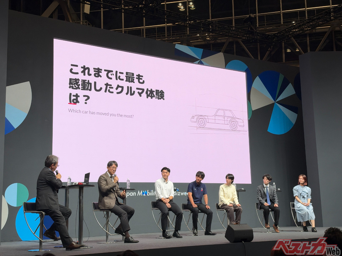写真右から、高橋百佳さん（東京音大）、出川貴久さん（日産栃木自動車大学校）、加藤介さん（成城大学自動車部）、上野亜斗瑠さん（慶應義塾大学体育会自動車部）、遠藤佑馬さん（早稲田大学大学院）、佐藤会長、司会。皆さんめっちゃ個性的なうえにめっちゃしっかりしていました
