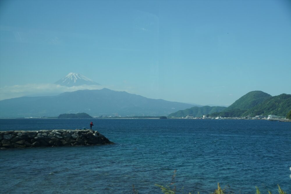 車窓から見る海越しの富士山