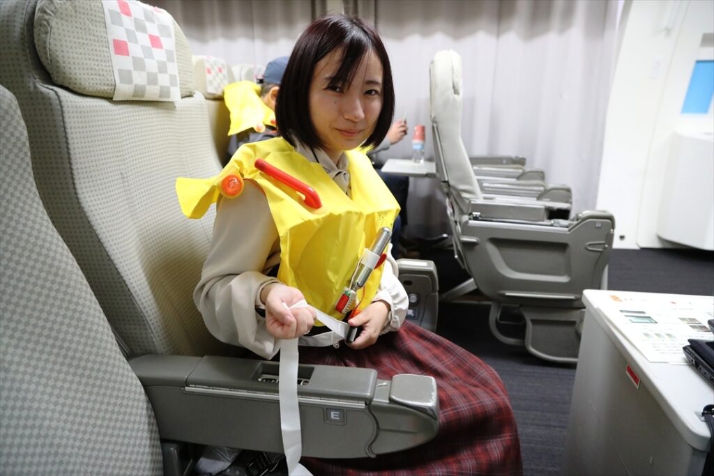 着水に備えて救命胴衣を着用する。