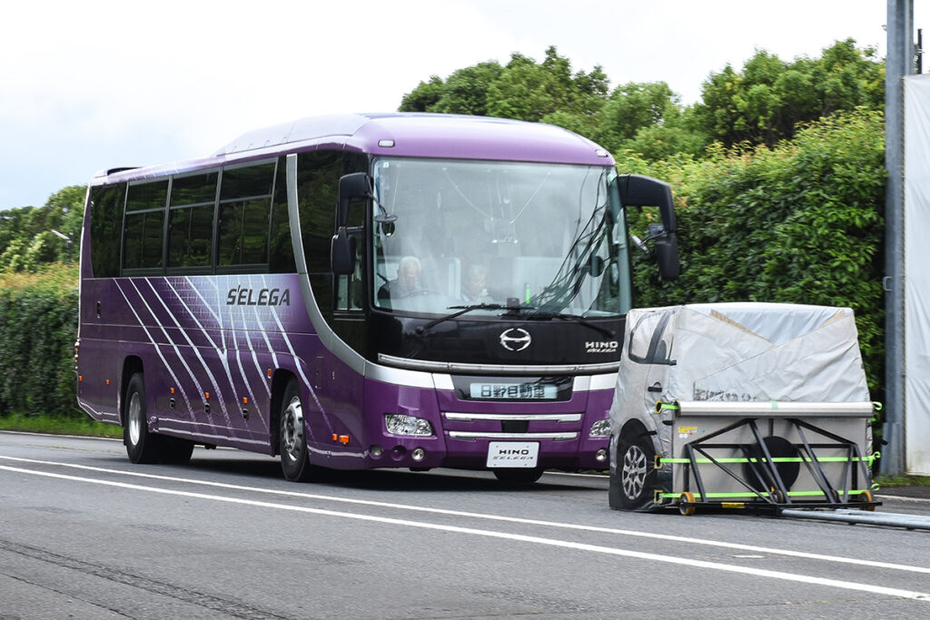 60km/hで走る旧型セレガが、30km/hで前走するEVT(デュトロが牽引している)を検知、PCSの緊急自動ブレーキによって追突を回避している様子