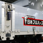 ロック装置の解除も自動化！　日本フルハーフとシンフォニアテクノロジーが共同開発中の「電動式アオリ開閉補助装置」のさらなる進化に驚き！